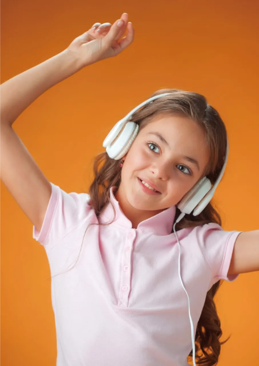 Child wearing headphone and dancing to the beat